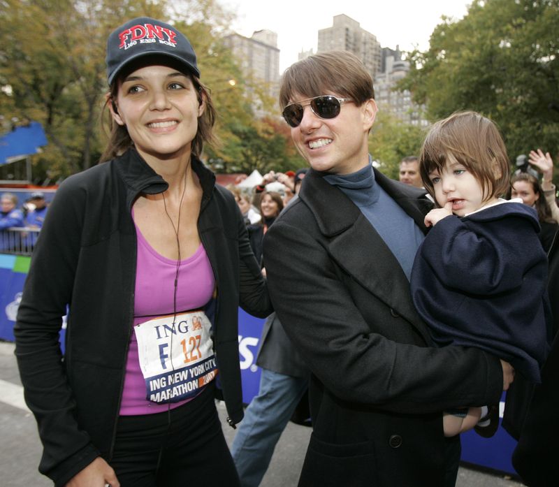 FILE -  In this Nov. 4, 2007 file photo, actress Katie Holmes joins her husband Tom Cruise as he holds their daughter Suri after Holmes finished the New York City Marathon in New York. Holmes' attorney Jonathan Wolfe said Friday June 29, 2012 that the couple is divorcing, but called it a private matter for the family. (AP Photo/Kathy Willens, file)