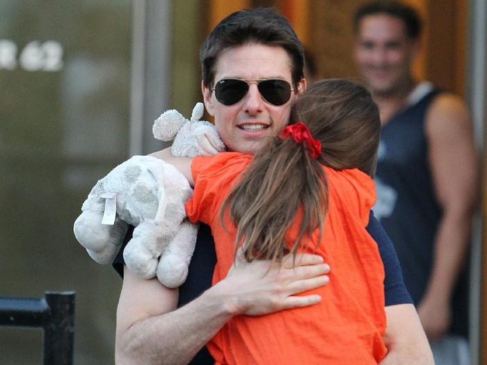 FILE -  In this Nov. 4, 2007 file photo, actress Katie Holmes joins her husband Tom Cruise as he holds their daughter Suri after Holmes finished the New York City Marathon in New York. Holmes attorney Jonathan Wolfe said Friday June 29, 2012 that the couple is divorcing, but called it a private matter for the family. (AP Photo/Kathy Willens, file)