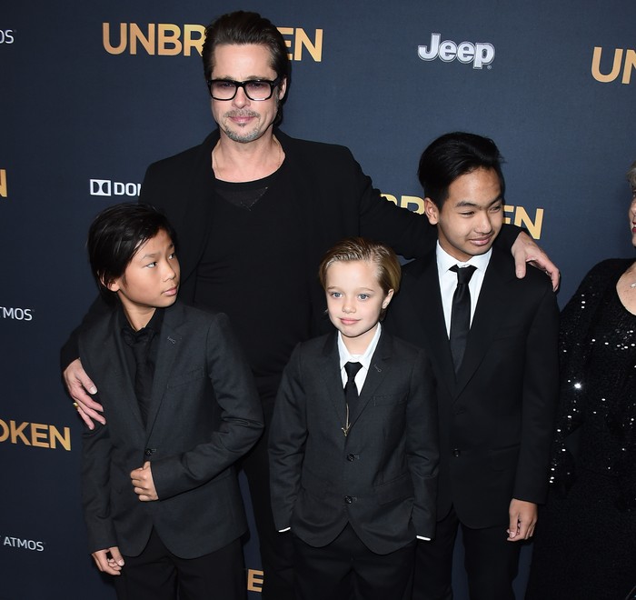 HOLLYWOOD, CA - DECEMBER 15:  (L-R) Pax Thien Jolie-Pitt, Shiloh Nouve Jolie-Pitt, actor Brad Pitt and Maddox Jolie Pitt attend the premiere of Unbroken at TCL Chinese Theatre IMAX on December 15, 2014 in Hollywood, California.  (Photo by Barry King/FilmMagic)