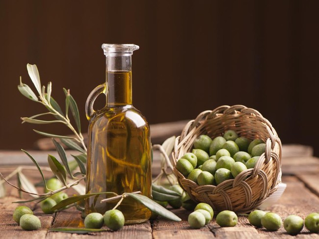 Olive oil and olives on wooden rustic table