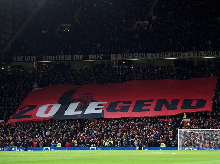 MANCHESTER, ENGLAND - DECEMBER 02: Fans of Manchester United wave a flag in support of Former Player and Manager, Ole Gunnar Solskjaer prior to the Premier League match between Manchester United and Arsenal at Old Trafford on December 02, 2021 in Manchester, England. (Photo by Shaun Botterill/Getty Images)