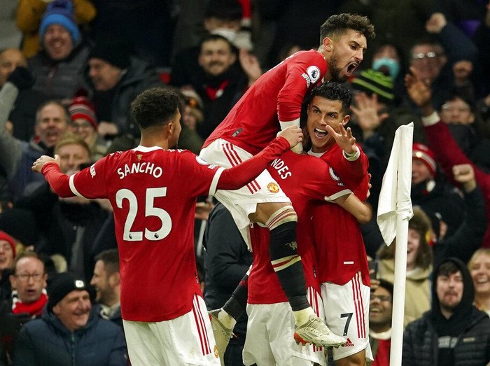 Manchester United's Cristiano Ronaldo, right, celebrates after scoring his side's second goal during the English Premier League soccer match between Manchester United and Arsenal at Old Trafford stadium in Manchester, England, Thursday, Dec. 2, 2021. (AP Photo/Dave Thompson)