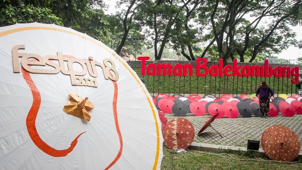 Pengunjung melihat-lihat payung yang dipamerkan pada Festival Payung 2021 di Taman Balekambang, Solo, Jawa Tengah, Jumat, (3/12).