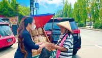 Pedagang peyek yang berjualan menggunakan sepeda juga tak luput dari bantuannya. Memborong seluruh peyek yang dibawa pedagang, Heni Tania membuat pedagang peyek terharu. Foto: Instagram/henitania