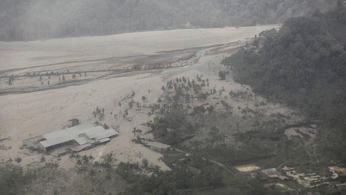 Foto Udara Dampak Erupsi Gunung Semeru Rumah dan bangunan tertutup abu erupsi Gunung Semeru di Lumajang, Jawa Timur, Indonesia, Minggu, 5 Desember 2021. Korban tewas akibat letusan gunung tertinggi di pulau Jawa berpenduduk terpadat di Indonesia itu bertambah berlipat ganda. (AP Photo/Trisnadi)