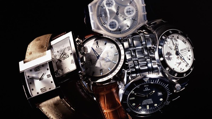 Leiden, The Netherlands - June 26, 2008: Product shot of a Gucci, Omega, Swatch, Seiko, Dolce & Gabbana wristwatch with leather and metal straps, shot in studio on black background.