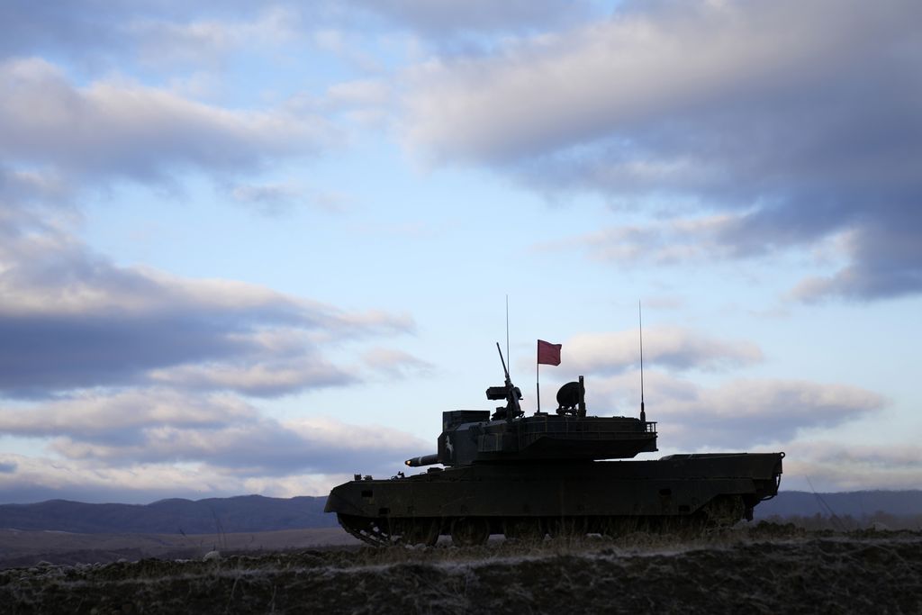 Japanese Ground-Self Defense Force (JGDDF) Type 90 tank aims its gun at a target during the annual drill with live ammunitions exercise at Minami Eniwa Camp Monday, Dec. 6, 2021, in Eniwa, northern Japan island of Hokkaido. Dozens of tanks and hundreds of soldiers fired explosives and machine guns in drills Monday on Japan's northern island of Hokkaido, a main stronghold for a nation that is perhaps the world's least-known military powerhouse.   (AP Photo/Eugene Hoshiko)