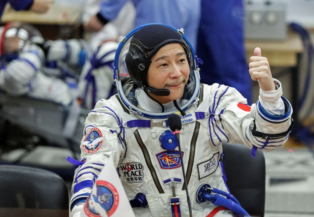 Japanese entrepreneur Yusaku Maezawa reacts as he speaks with his family after donning space suits shortly before the launch to the International Space Station (ISS) at the Baikonur Cosmodrome, Kazakhstan, December 8, 2021.  REUTERS/Shamil Zhumatov