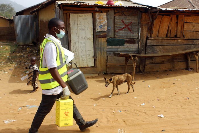 Virus Outbreak Nigeria Rural Vaccinations Yunusa Bawa, a community health worker, rides on a motorbike with a box of AstraZeneca coronavirus vaccines, in Sabon Kuje on the outskirts of Abuja, Nigeria, Monday, Dec 6, 2021. As Nigeria tries to meet an ambitious goal of fully vaccinating 55 million of its 206 million people in the next two months, health care workers in some parts of the country risk their lives to reach the rural population. (AP Photo/Gbemiga Olamikan)