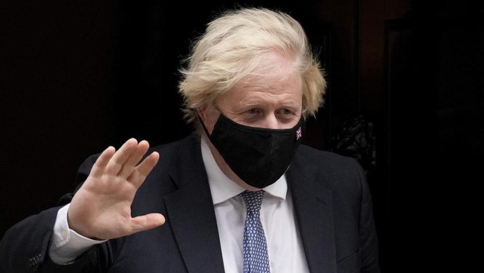British Prime Minister Boris Johnson waves at the media as he leaves 10 Downing Street to attend the weekly Prime Ministers Questions at the Houses of Parliament, in London, Wednesday, Dec. 8, 2021. (AP Photo/Matt Dunham)