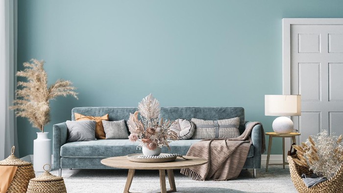 Home interior mock-up with blue sofa, wooden table and decor in blue living room, 3d render