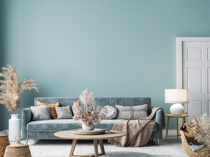 Home interior mock-up with blue sofa, wooden table and decor in blue living room, 3d render