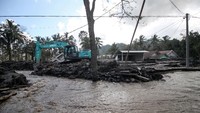 Petugas mengoperasikan ekskavator untuk membersihkan material Gunung Semeru yang menutupi jalan di Dusun Kamar Kajang, Sumberwuluh, Candipuro, Lumajang, Jawa Timur, Jumat (10/12/2021).