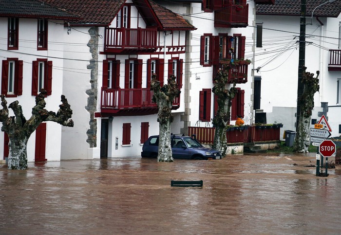 Cars on a flooded street caused by heavy rain in Bayonne, southwestern France, Friday, Dec. 10, 2021. Southwestern France is on alert for violent storms, high winds and floods. (AP Photo/Bob Edme)
