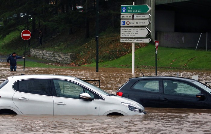 France Floods Cars on a flooded street caused by heavy rain in Bayonne, southwestern France, Friday, Dec. 10, 2021. Southwestern France is on alert for violent storms, high winds and floods. (AP Photo/Bob Edme)
