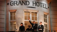 Dmitry Muratov (tengah) menyapa dari balkon hotel di Oslo, Norwegia. Sama seperti Maria Ressa, Dmitry Muratov juga dibenci oleh rezim berkuasa di Rusia karena tulisan-tulisannya. Muratov mendirikan media independen Novaya Gazeta. (AP Photo/Alexander Zemlianichenko)