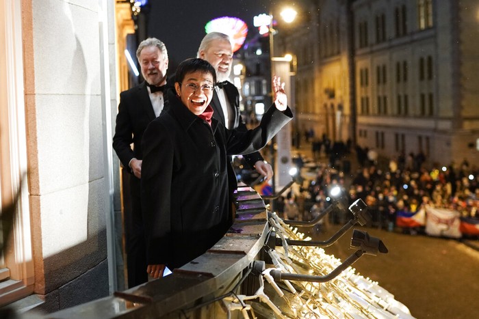 Nobel Peace Prize winners Dmitry Muratov from Russia, right, and Maria Ressa of the Philippines receive their awards from the Norwegian Nobel Committee's leader Berit Reiss-Andersen, left, during the Nobel Peace Prize ceremony at Oslo City Hall, Norway, Friday, Dec. 10, 2021. The Norwegian Nobel Committee cited Ressa and Muratov's fight for freedom of expression, stressing that it is vital in promoting peace. (Stian Lysberg Solum/Pool via AP)