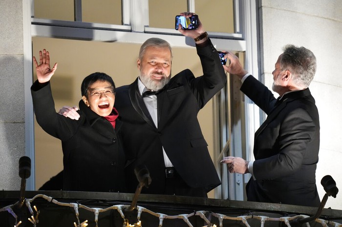 Norway Nobel Peace Prize Nobel Peace Prize winners Dmitry Muratov from Russia, right, and Maria Ressa of the Philippines receive their awards from the Norwegian Nobel Committee's leader Berit Reiss-Andersen, left, during the Nobel Peace Prize ceremony at Oslo City Hall, Norway, Friday, Dec. 10, 2021. The Norwegian Nobel Committee cited Ressa and Muratov's fight for freedom of expression, stressing that it is vital in promoting peace. (Stian Lysberg Solum/Pool via AP)