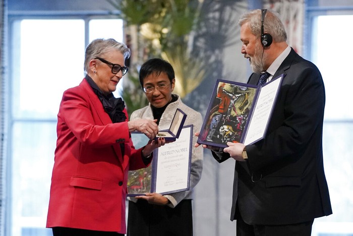 Norway Nobel Peace Prize Nobel Peace Prize winners Dmitry Muratov from Russia, right, and Maria Ressa of the Philippines receive their awards from the Norwegian Nobel Committee's leader Berit Reiss-Andersen, left, during the Nobel Peace Prize ceremony at Oslo City Hall, Norway, Friday, Dec. 10, 2021. The Norwegian Nobel Committee cited Ressa and Muratov's fight for freedom of expression, stressing that it is vital in promoting peace. (Stian Lysberg Solum/Pool via AP)