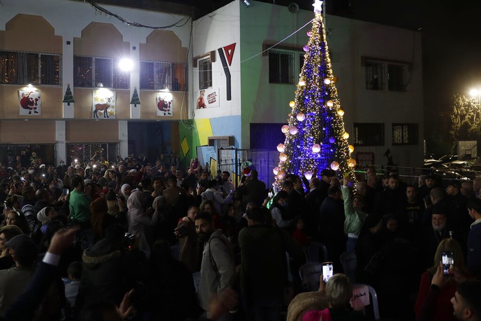 Palestinians Christmas Palestinians wear traditional uniforms perform a traditional folklore dance, Dabka, during while Christians celebrate lighting of the Christmas tree at the yard of Christian youth center in Gaza City, Friday, Dec. 10, 2021. (AP Photo/Adel Hana)