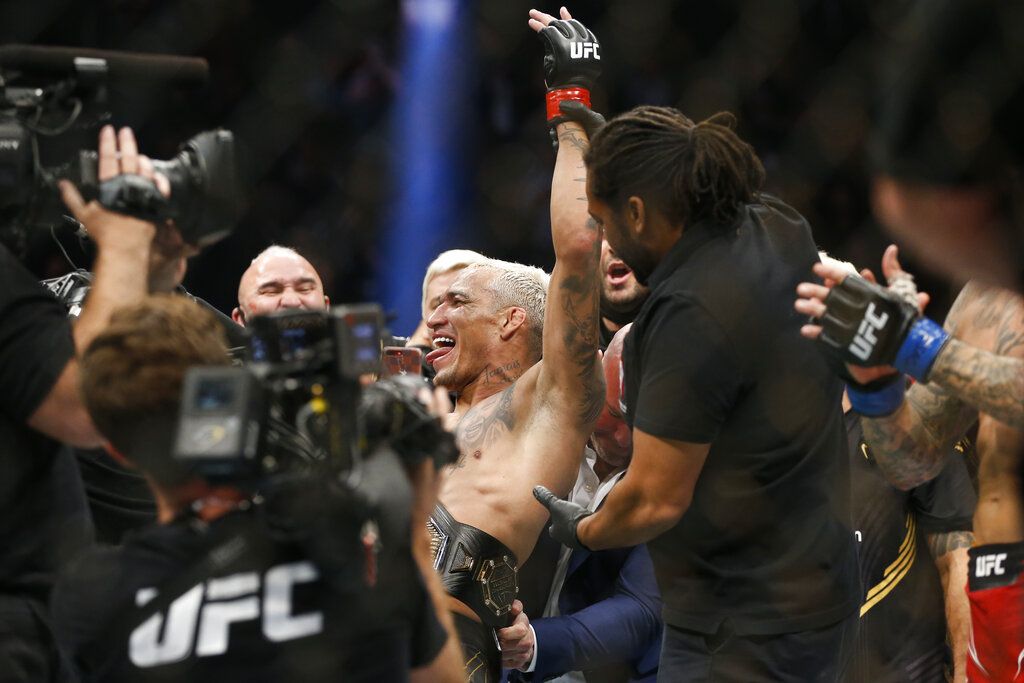 Charles Oliveira celebrates after defeating Dustin Poirier by submission in a lightweight mixed martial arts title bout at UFC 269, Saturday, Dec. 11, 2021, in Las Vegas. (AP Photo/Chase Stevens)