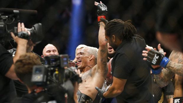 Charles Oliveira celebrates after defeating Dustin Poirier by submission in a lightweight mixed martial arts title bout at UFC 269, Saturday, Dec. 11, 2021, in Las Vegas. (AP Photo/Chase Stevens)