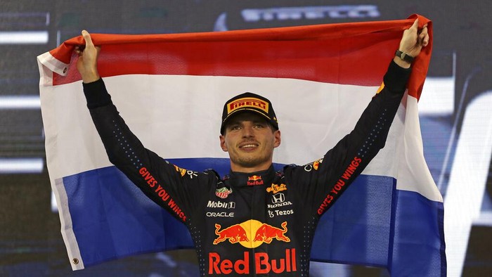 Red Bull driver Max Verstappen of the Netherlands celebrates on the podium after becoming F1 drivers world champion after winning the Formula One Abu Dhabi Grand Prix in Abu Dhabi, United Arab Emirates, Sunday, Dec. 12. 2021. (AP Photo/Kamran Jebreili, Pool)