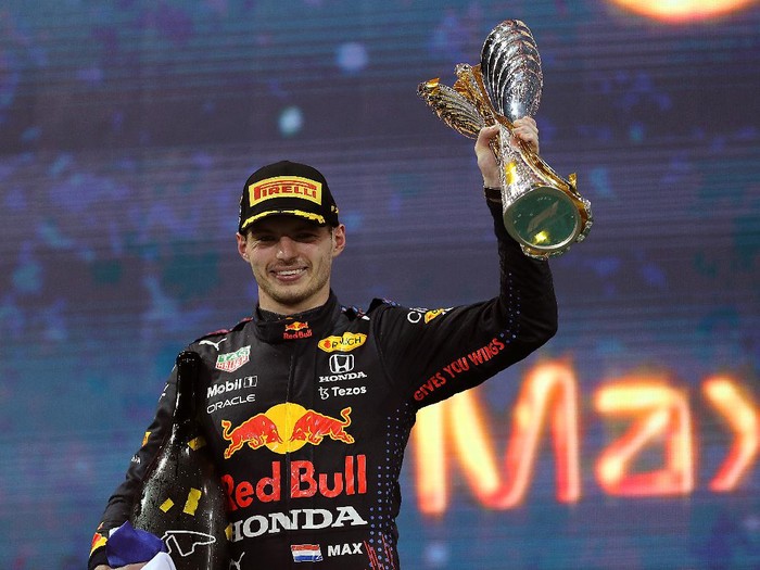 ABU DHABI, UNITED ARAB EMIRATES - DECEMBER 12: Race winner and 2021 F1 World Drivers Champion Max Verstappen of Netherlands and Red Bull Racing celebrates on the podium during the F1 Grand Prix of Abu Dhabi at Yas Marina Circuit on December 12, 2021 in Abu Dhabi, United Arab Emirates. (Photo by Kamran Jebreili - Pool/Getty Images)