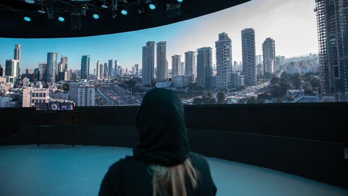 DUBAI, UNITED ARAB EMIRATES - SEPTEMBER 27: An Emirate woman watches the 360-degree video display at the Israeli Pavilion at Expo 2020 Dubai on September 27, 2021 in Dubai, United Arab Emirates (Photo by Andrea DiCenzo/Getty Images)