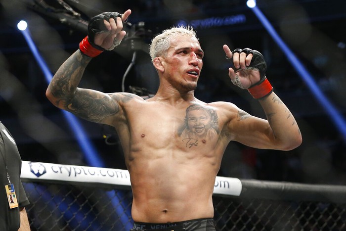Charles Oliveira reacts after defeating Dustin Poirier by submission in a lightweight mixed martial arts title bout at UFC 269, Saturday, Dec. 11, 2021, in Las Vegas. (AP Photo/Chase Stevens)