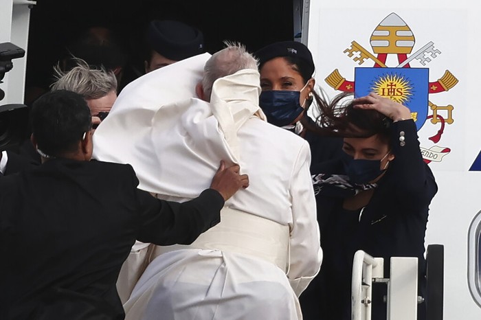 Greece Pope A gust of wind blows Pope Francis's mantle as walks to the airplane before his departure from Eleftherios Venizelos International Airport in Athens, Greece, Monday, Dec. 6, 2021. Francis' five-day trip to Cyprus and Greece has been dominated by the migrant issue and Francis' call for European countries to stop building walls, stoking fears and shutting out