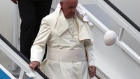 Topi kecil Paus Fransiskus terbang tertiup angin saat tiba di Bandara Havana, Kuba (19/9/2015). Paus Fransiskus mempunyai nama lahir Jorge Mario Bergoglio dan sempat menjadi Uskup Agung Beenos Aires (1998-2013) dan kardinal (2001-2013). (Photo: Carl Court/Getty Images)