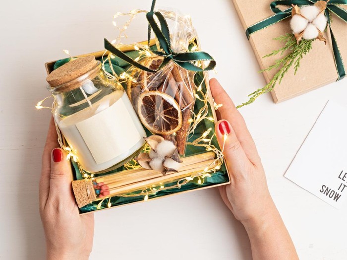 Refined Christmas gift basket for romantic holidays with aroma candle and matches. Corporate or personal present for family and friends.