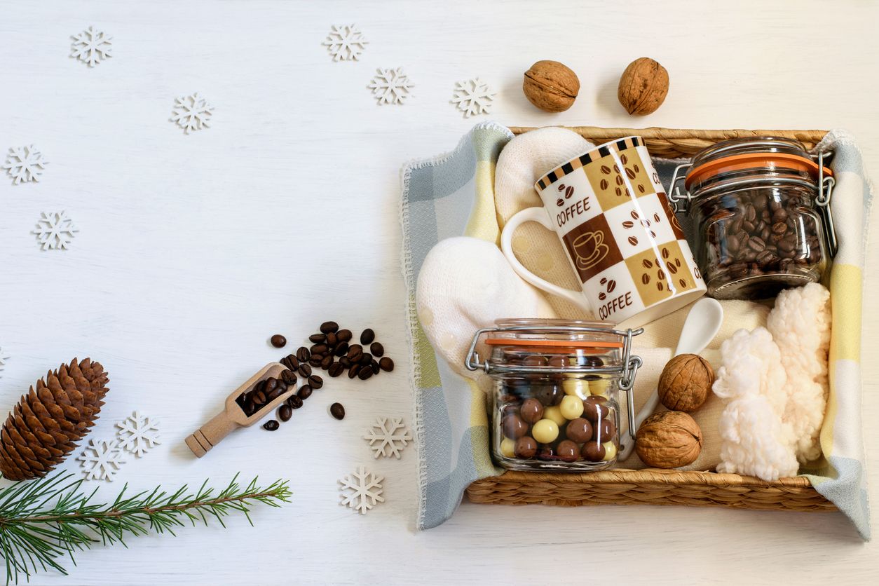 Care package, handmade gift box with warm socks, coffee, coffee cup and chocolate beans for Christmas or New Year. Personal festive eco friendly basket for your family or friends.