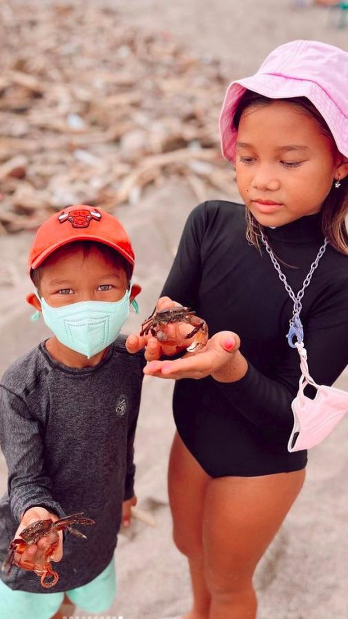 Jennifer Bachdim ajarkan anak bersih-bersih pantai.