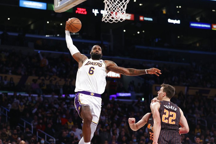 Los Angeles Lakers forward LeBron James (6) goes up for a slam dunk against the Orlando Magic during the second half of an NBA basketball game in Los Angeles, Sunday, Dec. 12, 2021. The Lakers won 106-94. (AP Photo/Ringo H.W. Chiu)