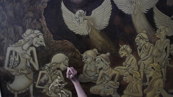 Seniman Jogja Buat Lukisan Rohani Bercorak Wayang Petrus Herjaka (64) sedang menyelesaikan lukisan bertemakan kelahiran Tuhan Yesus di studio lukis di Bantul, Yogyakarta, Selasa (14/12/2021). Lukisan dengan pendekatan teknik penggambaran wayang purwo tersebut narasi dari menyambut Natal saat pandemi.