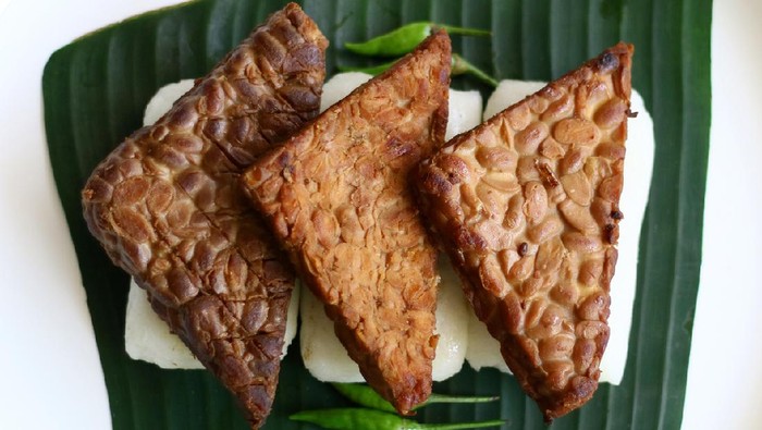 Jadah bacem on banan leaf. Jadah combined with tempe bacem. Indonesian food from yogyakarta.