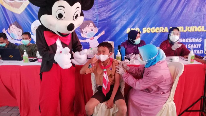 Para Badut Temani Anak-anak Usia 6-11 Tahun Suntik Vaksin di Kota Pasuruan
