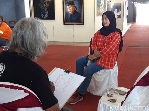 Darto, melukis sketsa wajah menggunakan media kopi, Sabtu (18/12/2021).