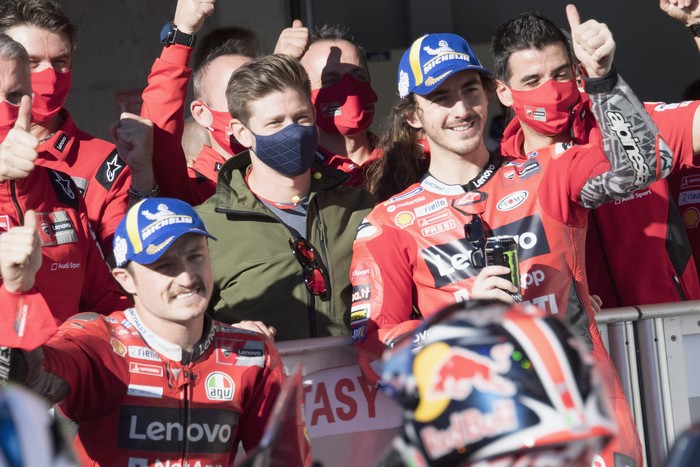 LAGOA, ALGARVE, PORTUGAL - NOVEMBER 06: (L-R)  Jack Miller of Australia and Ducati Lenovo Team, Casey Stoner of Australia) and Francesco Bagnaia of Italy and Ducati Lenovo Team celebrate at the end of the MotoGP qualifying practice during the MotoGP Of Portugal - Qualifying on November 06, 2021 in Lagoa, Algarve, Faro. (Photo by Mirco Lazzari gp/Getty Images)