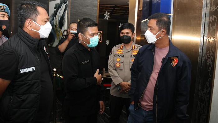 Sekuriti menghalangi polisi saat razia di Embassy Club, SCBD, Jakarta Selatan, Minggu (19/12/2021).