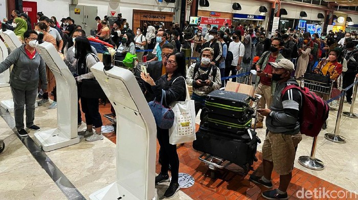 Suasana penumpang pesawat membludak di Bandara Soekarno-Hatta, Tangerang, Provinsi Banten. Menjelang masa libur Natal 2021 dan tahun baru 2022, masyarakat kembali dikejutkan dengan terdeteksinya COVID-19 varian Omicron di Indonesia.