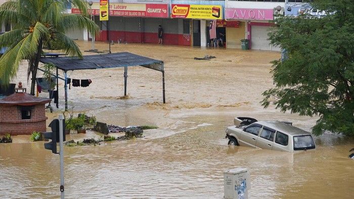 Mobil Mewahnya Terendam Banjir, Wanita Ini Malah Nyantai Makan Burger
