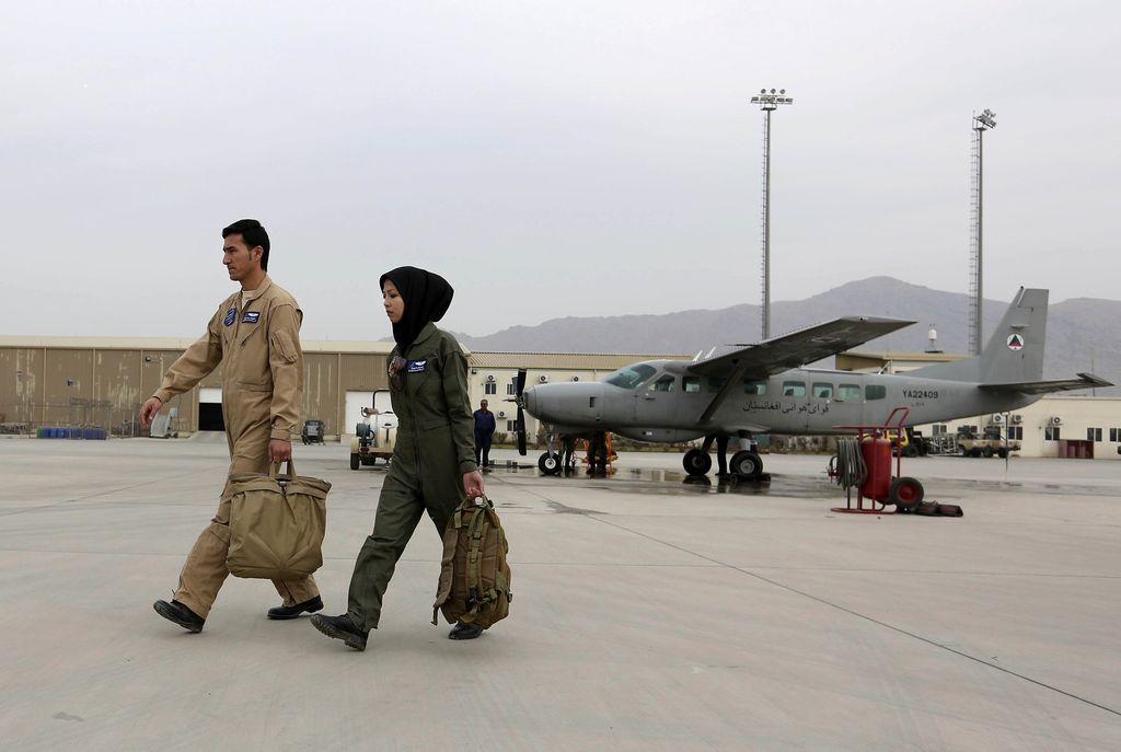 In this Monday, Nov. 21, 2016, photo, Capt. Safia Ferozi, 26, speaks in an interview with the Associated Press after her flight, at the Afghan military airbase in Kabul, Afghanistan. From a childhood as a refugee, Capt. Safia Ferozi is now flying a transport plane for Afghanistan's air force as the country's second female pilot, a sign of the efforts to bring more women into the armed forces. (AP Photo/Rahmat Gul)