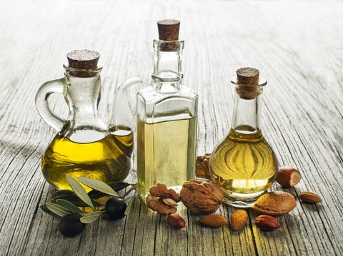 Olive, walnut and almond oil on wooden background