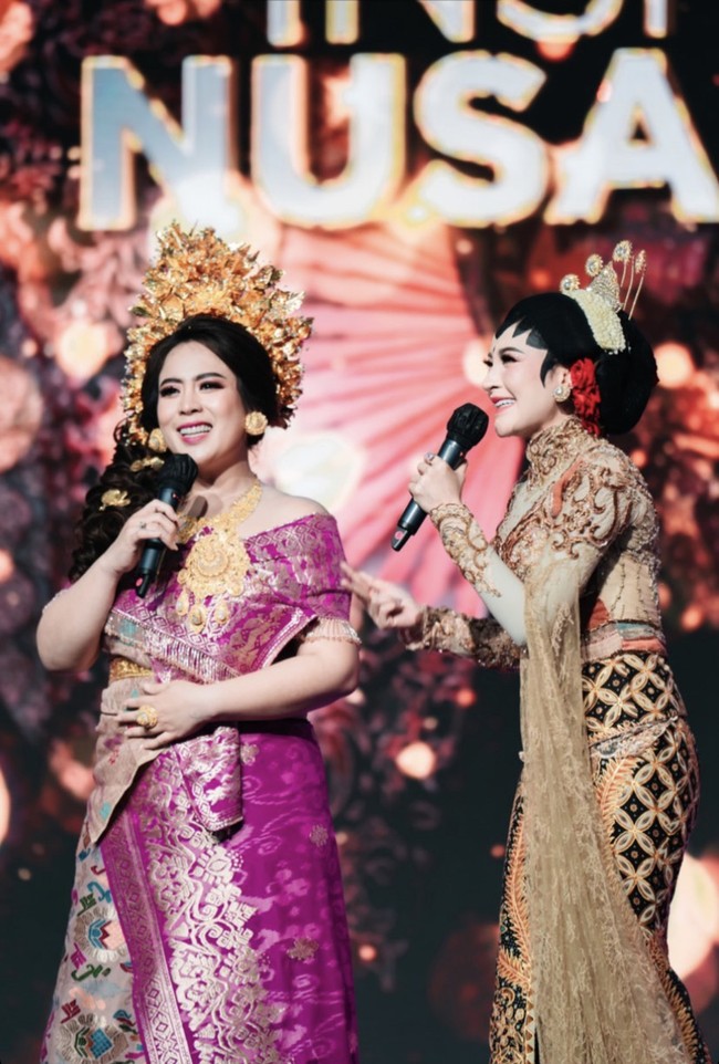 Shandy Purnamasari tampil bersanding dengan Maharani yang mengenakan sanggul dan hiasan rambut berupa bunga emas dan bunga segar yang dibentuk ke samping kanan. Rekan bisnisnya itu memakai busana adat Bali. Foto: Dok. Instagram @artmospoto.
