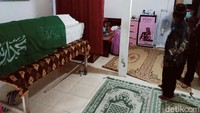 Di rumah bercat putih krem tersebut, peti Mbah Minto berbalut kain hijau bertuliskan kalimat syahadat.
