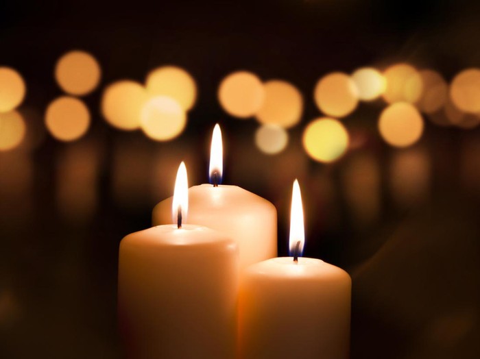 Three candles on dark background