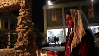 Umat Kristiani di Irak menyalakan lilin dalam misa Natal di Gereja St. Teresa di Basra, (24/12). (AP Photo/Nabil al-Jurani)